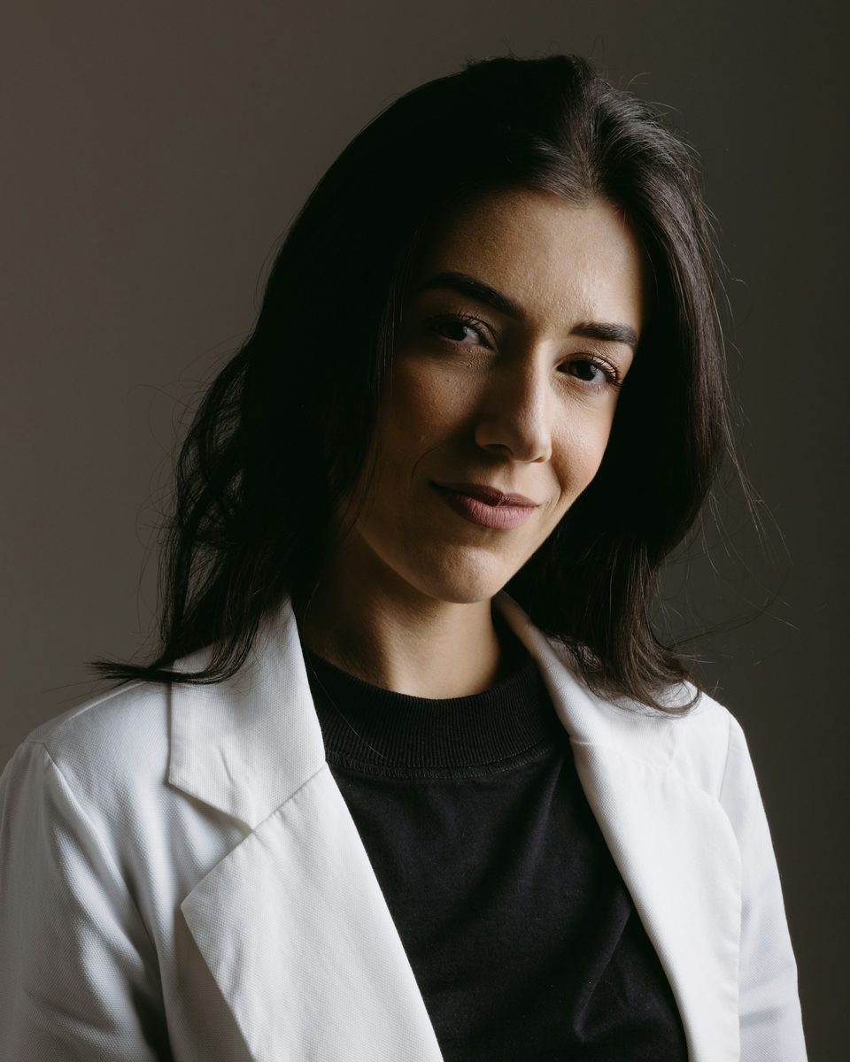 Confident young healthcare professional in a white coat